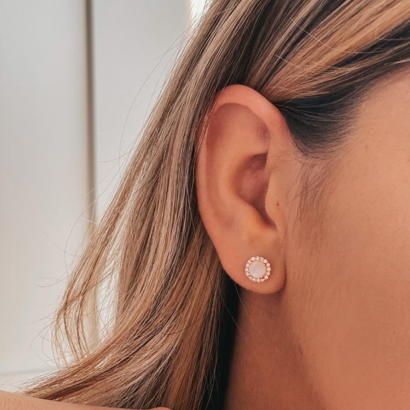 Zbliżenie na ucho kobiety z kolczykiem Keira Rose Silver z kamieniem księżycowym.